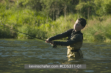 OREGON, FISHING: Boy, aged 8, fly-fishing, Deschutes River, Oregon