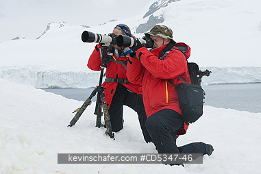 ANTARCTICA, TOURISM: Photographing Penguins in the snow, Antarctic Peninsula, Antarctica