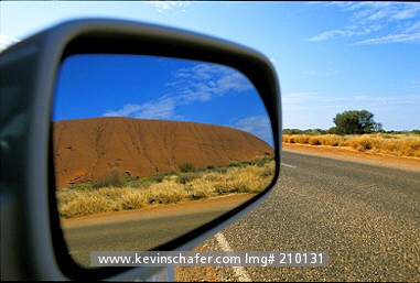 AUSTRALIA: Australia, Uluru, Ayers Rock, The famed giant sandstone massif as viewed in rear view mirror.